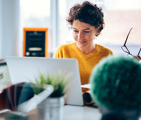 A woman looking at a laptop computer