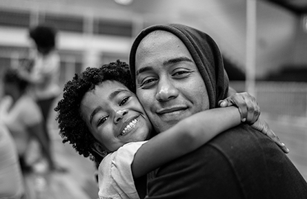 A child hugs his father