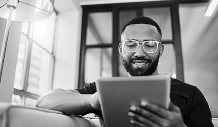 A young man scrolling on a tablet