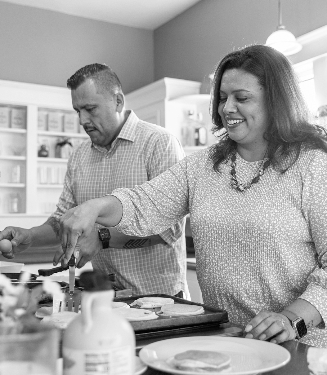 A couple in their kitchen cooking together