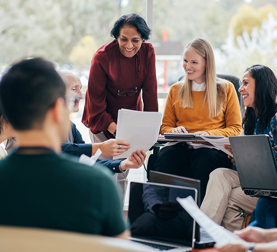 A group of people sit in a meeting together