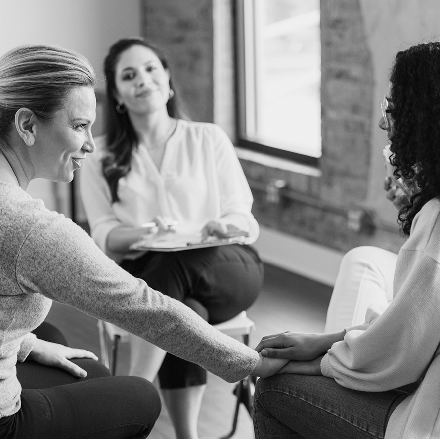 Three women sitting in a meeting together