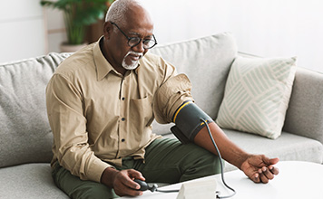 A man checks his blood pressure. 