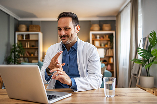 A health care provider on a video call from their home office.
