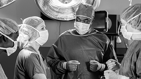 Three doctors talk to each other before surgery. 