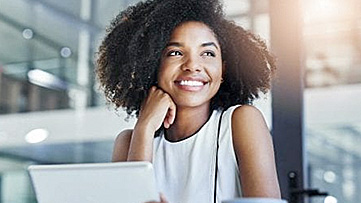 A woman smiles while working online