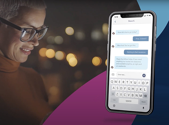 A woman looks down, with a screenshot of a text conversation on a phone next to her