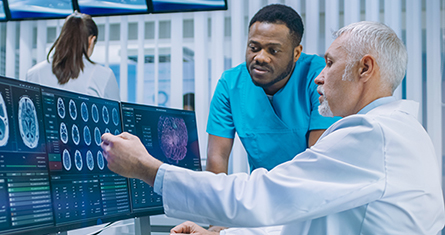 Two health care professionals look over a brain scan together.