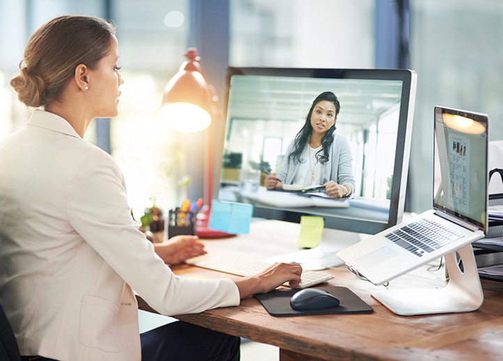 Two professionals connect in an online meeting