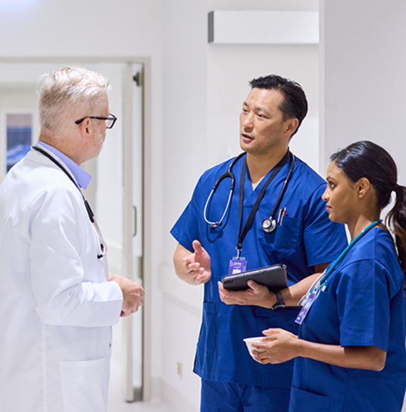 Three health care professionals having a discussion