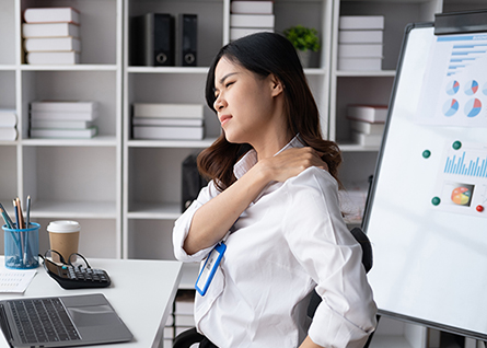 Woman rubbing a sore shoulder