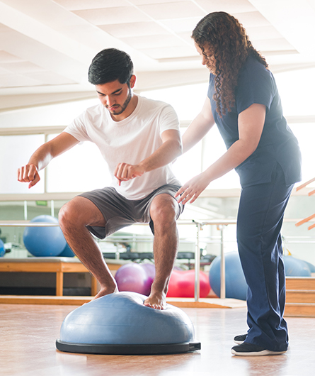 A man doing exercises with a physical therapist
