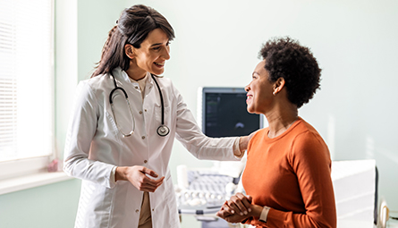 a medical provider speaks with a patient