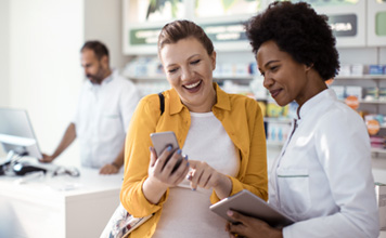 Two women look up benefits online