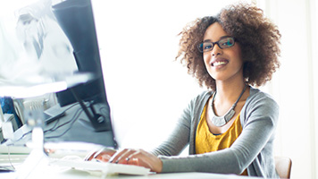 A student smiles while learning online