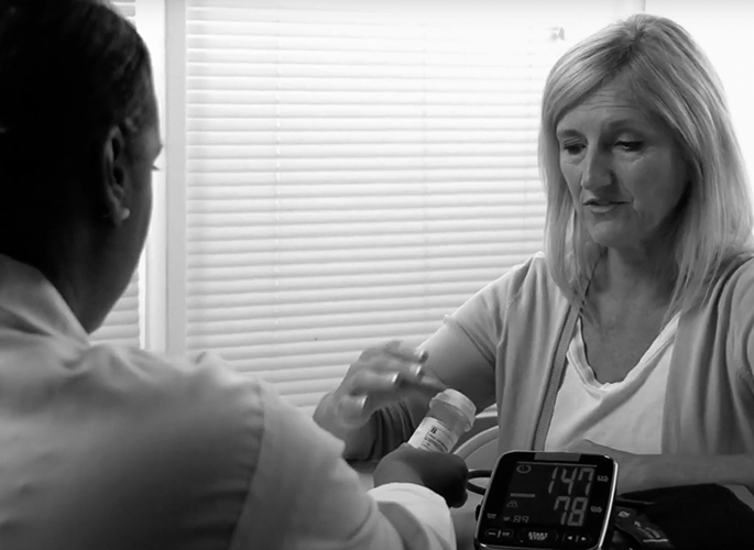 A pharmacist goes over a prescription with a person