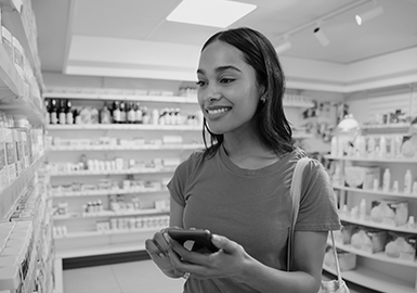 A woman looks over a selection of supplements. 