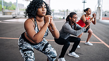 Three people work out together