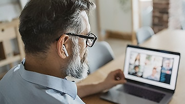 A man attends an online meeting