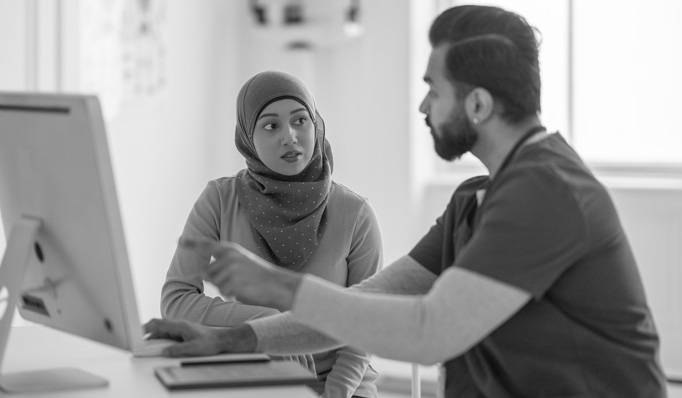 A woman speaks with a health care professional.