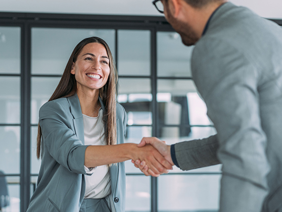 Two business professionals shake hands
