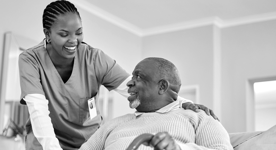 A nurse smiles as she talks with her patient. 