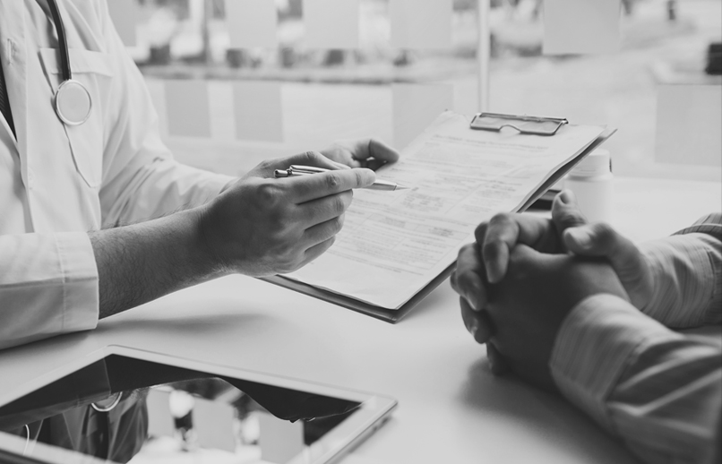 A health care provider holds a pen and clipboard