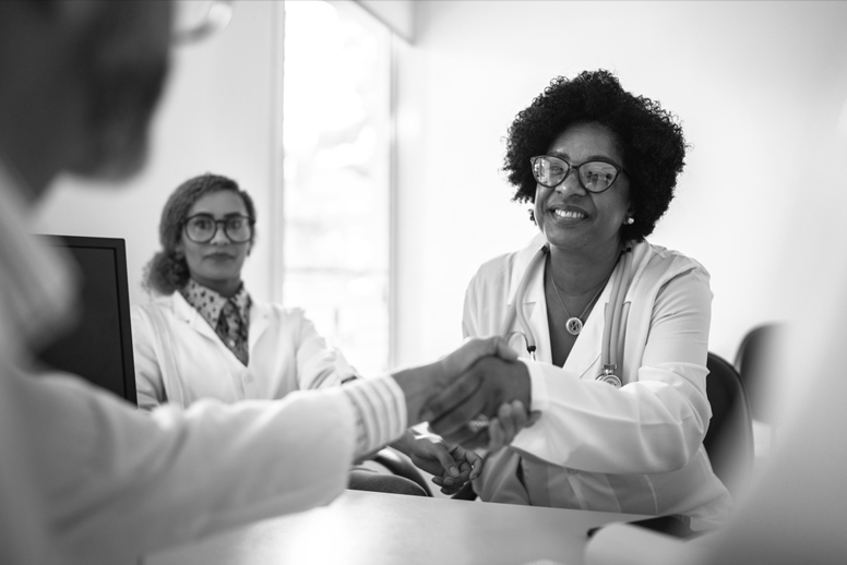 Two medical professionals shake hands