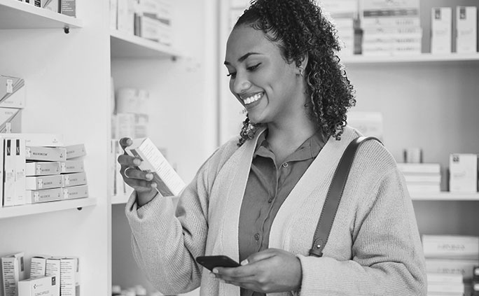 A woman reading a medication label