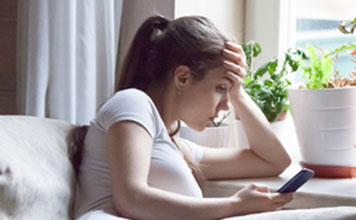 A woman looks for resources on her smartphone