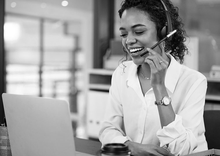 A woman helps someone with their claim over the phone. 