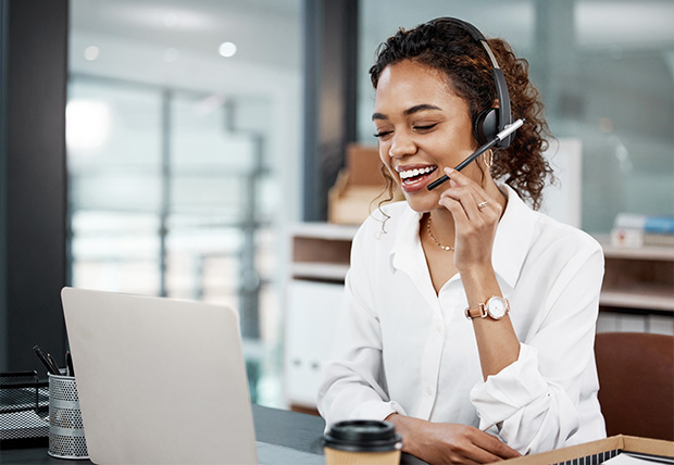 A woman helps someone with their claim over the phone. 