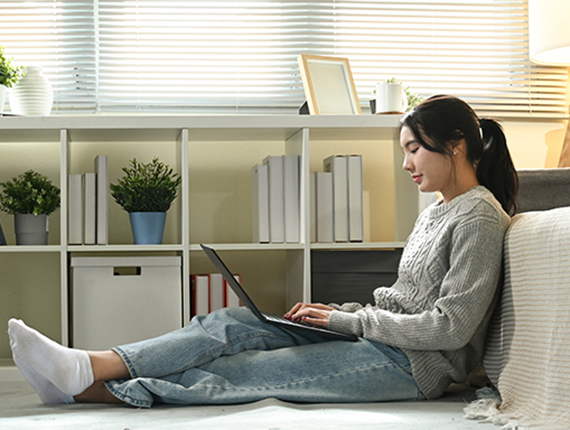 Person working with computer sitting on the floor