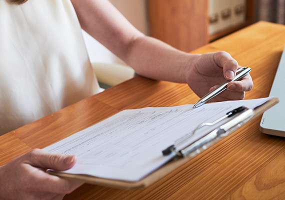 A woman looks over a form in her doctor's office. 