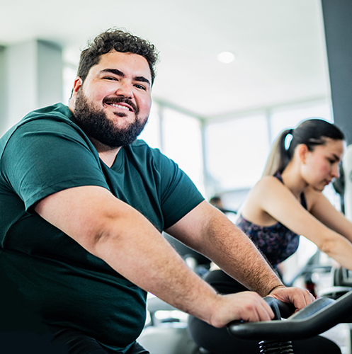 A man smiles while working out