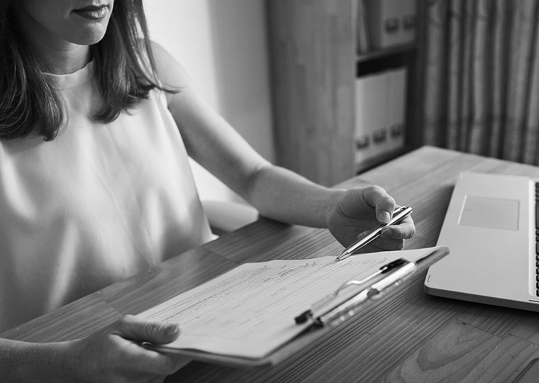A woman looks over a form in her doctor's office. 