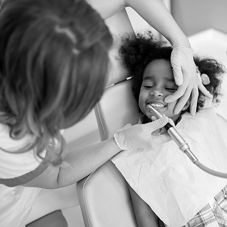 A little girl gets her teeth cleaned. 