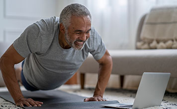 A man takes an online yoga class.