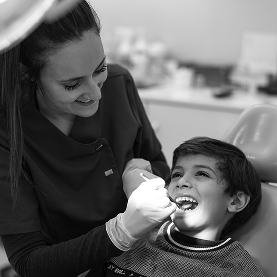 picture of dentist examingin child's teeth