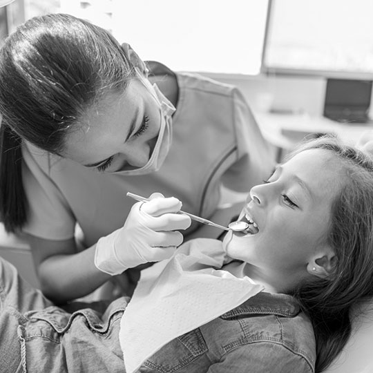 Child undergoing a dental exam.