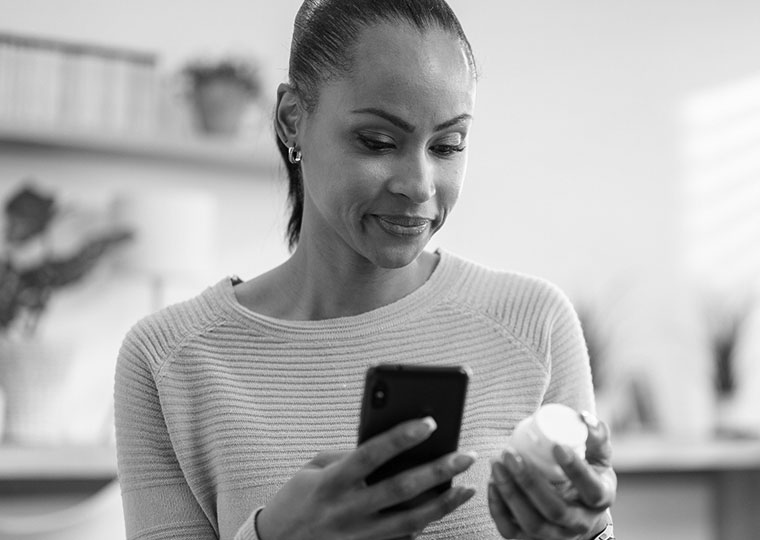 woman looking at prescription bottle