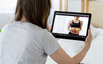 A woman watches a health video online