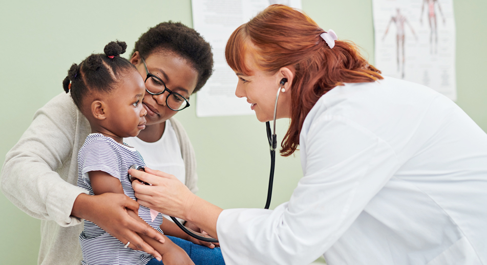 BCBSM provider listening to a young patient's heartbeat