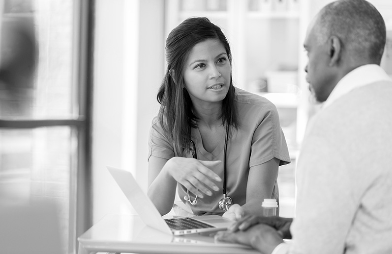 A doctor talks with her patient.