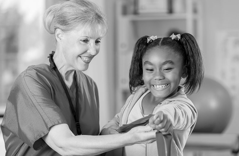 A nurse gives a little girl a checkup. 