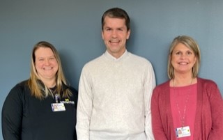 Dr. Savage stands with Meranda Collins, left, and Bonnie Khabir, right.